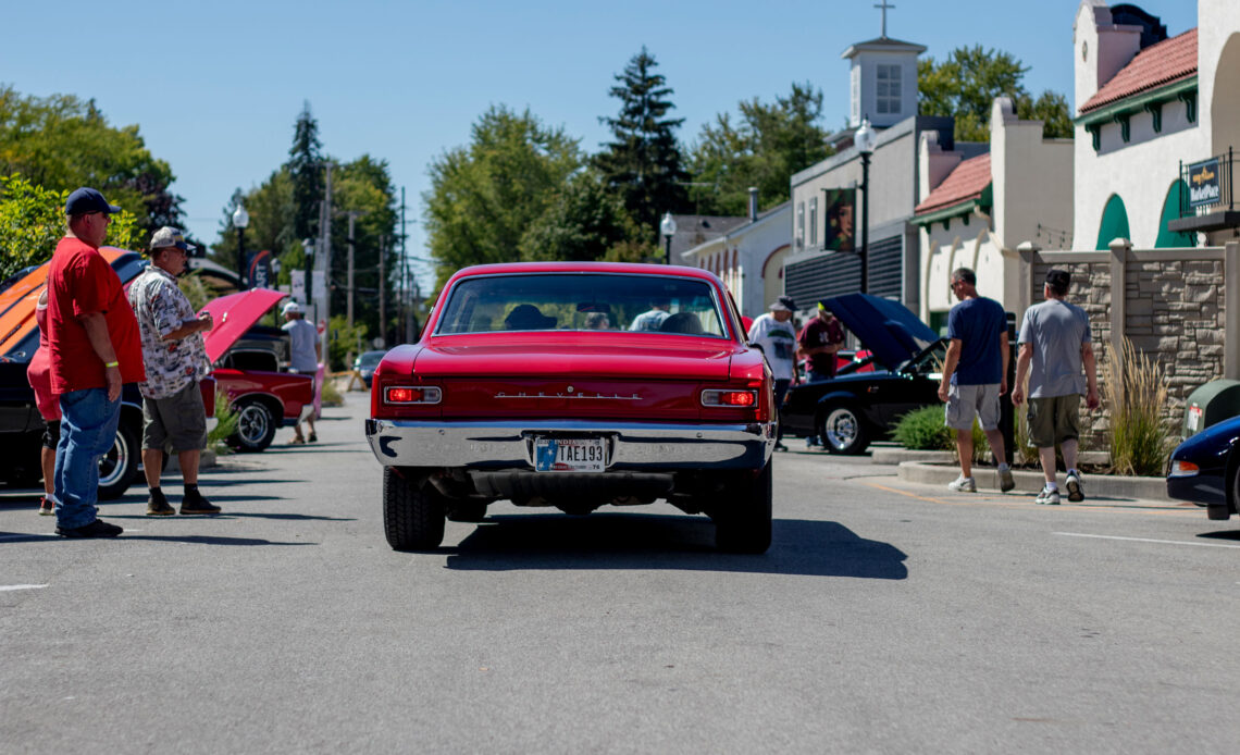 Photo of muscle car driving down street.